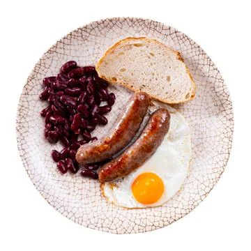 Portion of breakfast food is fried egg and pork sausage with stewed beans Stock Photos