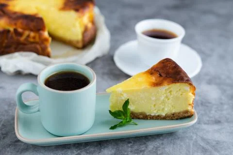 Portion of cheesecake with coffee. Stock Photos