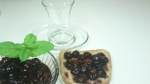Portion Of Cherry Jam Rotating On A WhitePlate Stock Footage 91665382