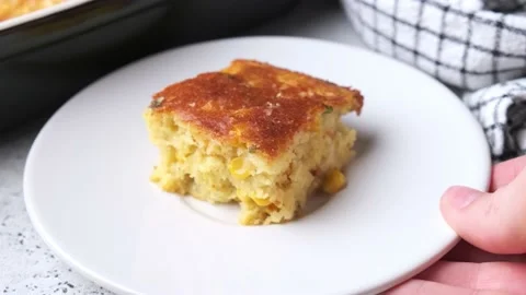 Portion of Christmas cheddar cornbread on white plate, close-up. Stock Footage 217675987