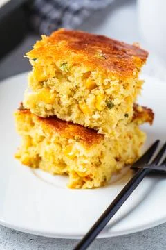 Portion of Christmas cheddar cornbread on white plate. Festive recipe food .. Stock Photos