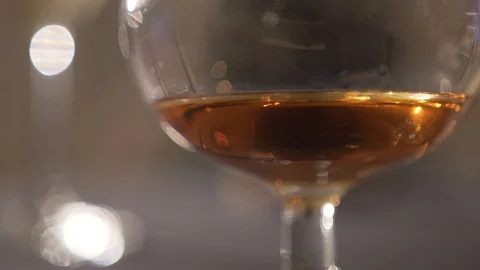 Portion of cognac in a glass goblet Stock Footage 127750275