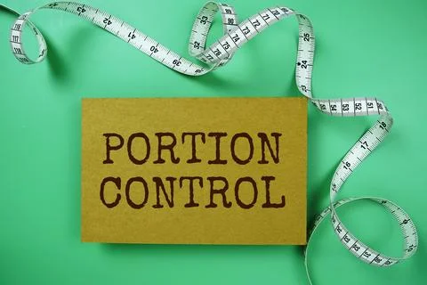 Portion Control text on paper card with Measuring meter top view on green b.. Stock Photos