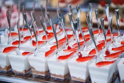Portion cups with strawberries and cream for a buffet table. Stock Photos