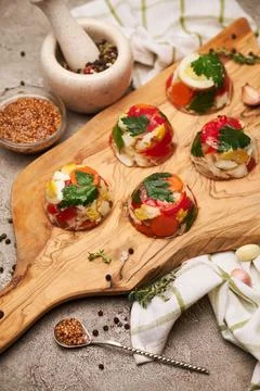 Portion of delicious chicken aspic on serving board on concrete table Stock Photos