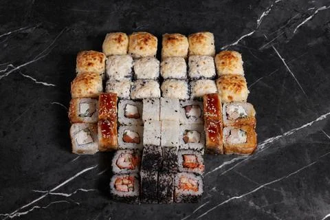 A portion of different rolls on the table, japanese food, sushi set on marble Stock Photos