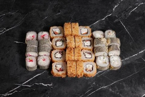 A portion of different rolls on the table, japanese food, sushi set on marble Stock Photos