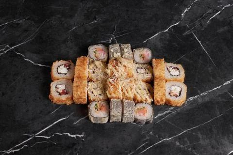 A portion of different rolls on the table, japanese food, sushi set on marble Stock Photos
