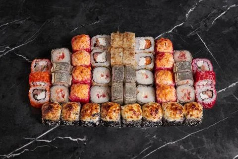 A portion of different rolls on the table, japanese food, sushi set on marble Stock Photos