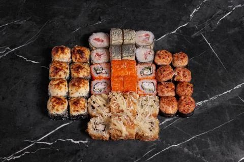 A portion of different rolls on the table, japanese food, sushi set on marble Stock Photos