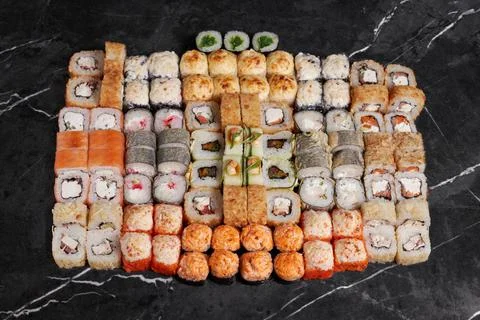 A portion of different rolls on the table, japanese food, sushi set on marble Stock Photos
