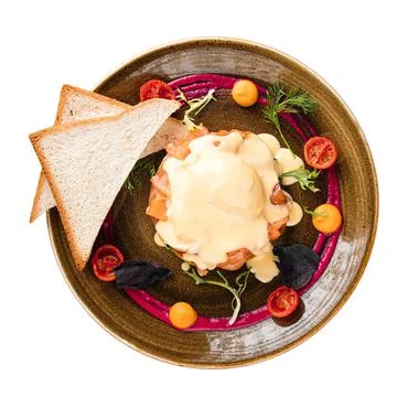 Portion of eggs benedict with salmon and sauce Stock Photos