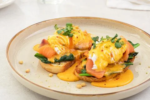 Portion of eggs benedict toast with salmon Stock Photos