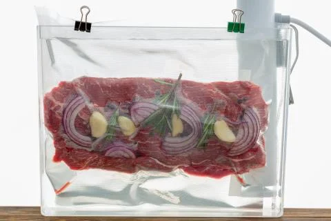 Portion of flat iron beef steak sous-vide cooking Stock Photos