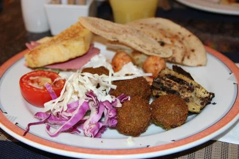 Portion of fresh vegetables cabbage, cutlets and stuffed tomato at restaurant Stock Photos
