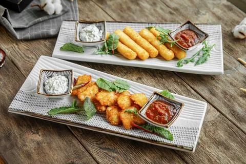 Portion of fried appetizers with sauces Stock Photos