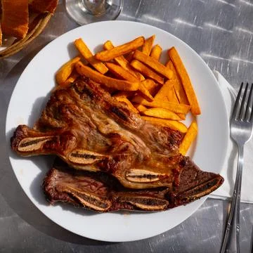 Portion of fried potatoes with beef steak Stock Photos