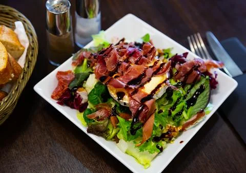 Portion of goat cheese salad Stock Photos