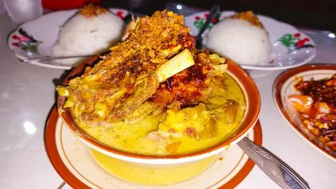 A portion of goat satay, curry, and rice on plate Stock Photos
