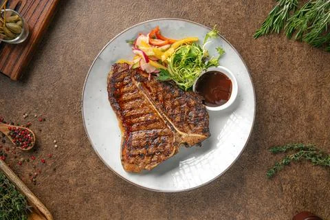 Portion of grilled beef t bone steak Stock Photos