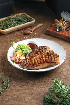 Portion of grilled beef t bone steak Stock Photos