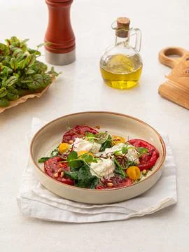 Portion of grilled tomatoes and stracciatella Stock Photos