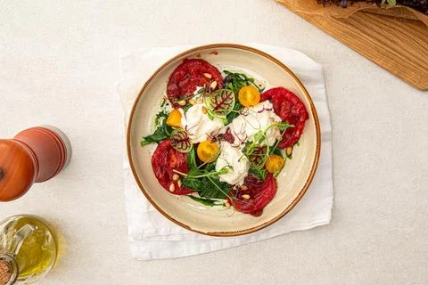 Portion of grilled tomatoes and stracciatella Stock Photos