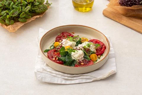 Portion of grilled tomatoes and stracciatella Stock Photos