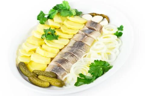 Portion of herring fish fillets with potato onion Stock Photos