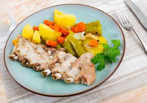 Portion of just cooked ribs with vegetables Stock Photos