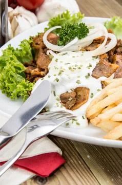Portion of kebab meat with chips Stock Photos