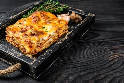 Portion of Lasagna with mince beef meat and tomato bolognese sauce in a wooden Stock Photos