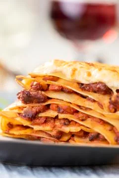 Portion of lasagna with wine Stock Photos