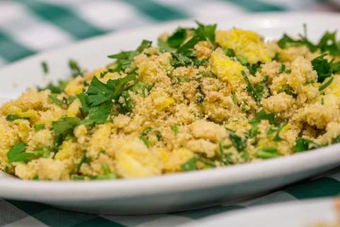 Portion of manioc farofa with eggs, typical Brazilian dish called farofa on g Stock Photos