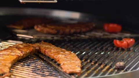 Portion of marinated beef ribs grilling on a grill Video stock 115078472