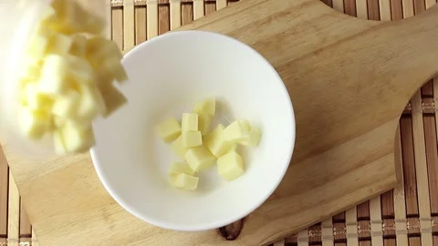 Portion of mozzarella cheese cubes placed in white ceramic bowl on cutting .. Stock Footage 252141609