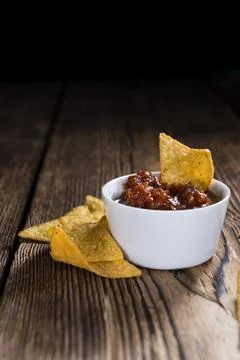 Portion of Nachos (with Salsa Dip) on an old wooden table Stock Photos