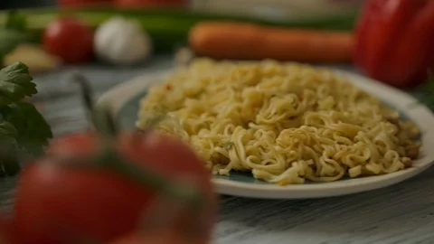 Portion of noodles on plate amidst assorted vegetables Stock Footage 121648559