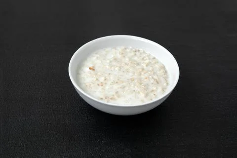 Portion of oatmeal - dark background Fotos Stock