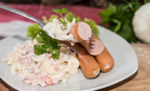 Portion of pasta salad with sausages Stock Photos