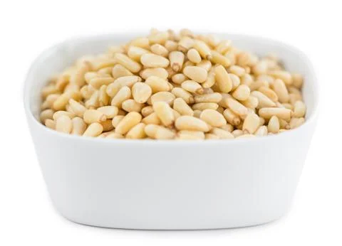 Portion of Pine Nuts isolated on white Stock Photos
