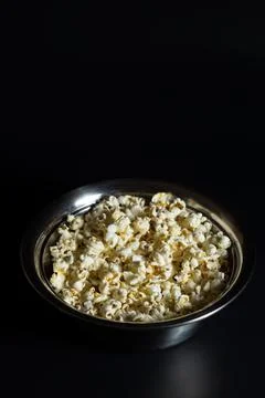 Portion of popcorn. Popcorn on black. Stock Photos