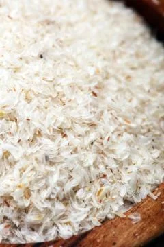 Portion of Psyllium Seeds on rustic dark background. Psyllium seed husks Foto stock