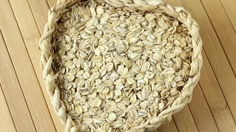 Portion of raw rolled oats rotating in the basket Stock Footage 275511950