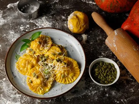 A portion of ready-made pumpkin ravioli. On a table sprinkled with flour, with a Stock Photos