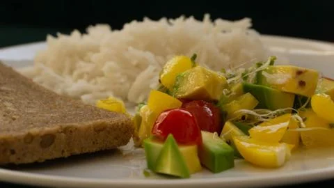 Portion of rice with salad and a slice of bread, healthy food Stock Photos