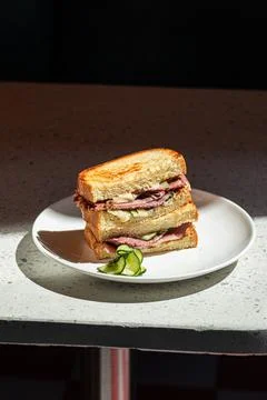 Portion of sandwich with pickles on the cafe table Stock Photos