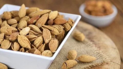 Portion of shelled, roasted Almonds (seamless loopable, 4K) Stock Footage 83846632