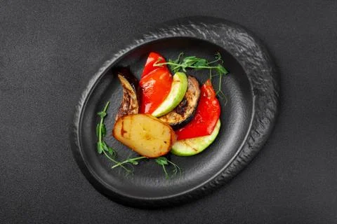 Portion of side dish - assorted grilled vegetables, potatoes, zucchini, eggplant Stock Photos
