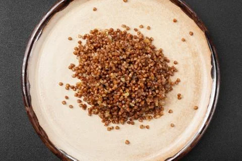Portion of side dish in gray plate - boiled buckwheat porridge Stock Photos